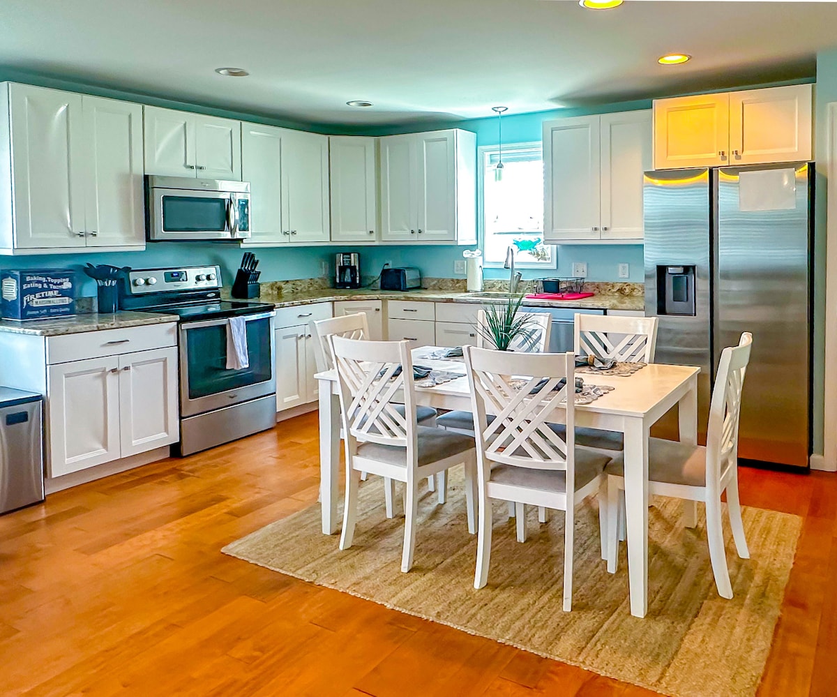 Kitchen with stainless appliances and a dining table for six