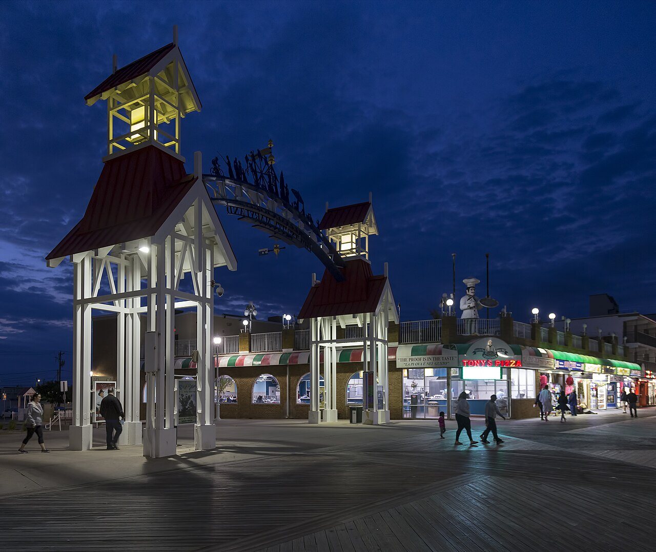 The Ocean City boardwalk entrance arch lit up at night